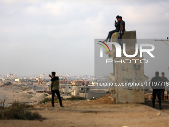 Palestinians are walking along the coastal Rashid road in the Nuseirat refugee camp in the central Gaza Strip on April 30, 2024, amid the on...