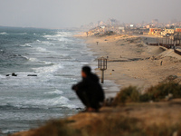 Palestinians are walking along the coastal Rashid road in the Nuseirat refugee camp in the central Gaza Strip on April 30, 2024, amid the on...