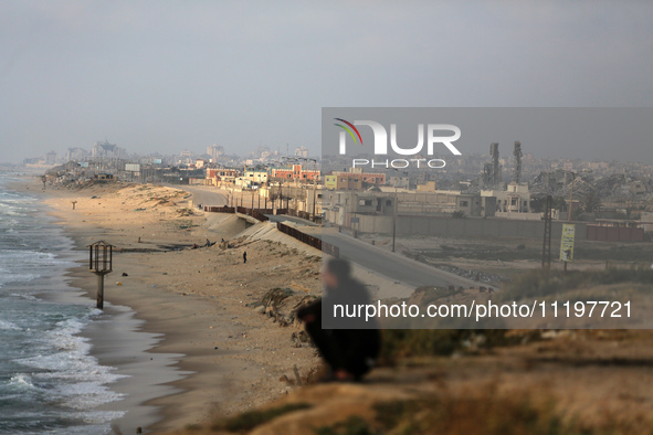 Palestinians are walking along the coastal Rashid road in the Nuseirat refugee camp in the central Gaza Strip on April 30, 2024, amid the on...