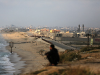 Palestinians are walking along the coastal Rashid road in the Nuseirat refugee camp in the central Gaza Strip on April 30, 2024, amid the on...