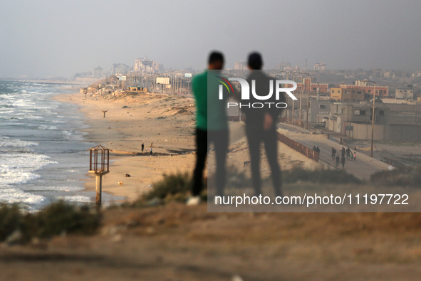 Palestinians are walking along the coastal Rashid road in the Nuseirat refugee camp in the central Gaza Strip on April 30, 2024, amid the on...