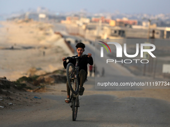 Palestinians are walking along the coastal Rashid road in the Nuseirat refugee camp in the central Gaza Strip on April 30, 2024, amid the on...