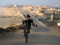 Palestinians are walking along the coastal Rashid road in the Nuseirat refugee camp in the central Gaza Strip on April 30, 2024, amid the on...