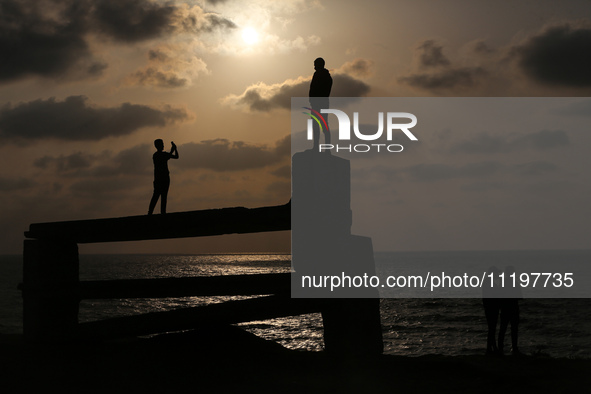 Palestinians are walking along the coastal Rashid road in the Nuseirat refugee camp in the central Gaza Strip on April 30, 2024, amid the on...