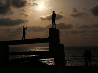 Palestinians are walking along the coastal Rashid road in the Nuseirat refugee camp in the central Gaza Strip on April 30, 2024, amid the on...