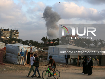 A smoke plume is billowing following Israeli bombardment in Deir Al-Balah, in the central Gaza Strip, on April 30, 2024, amid the ongoing co...