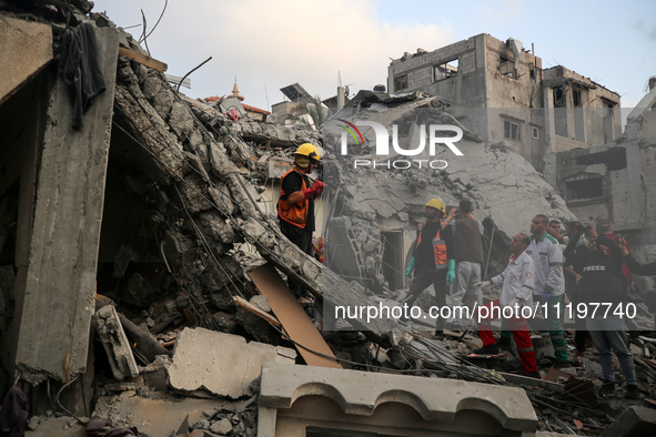 Palestinians are inspecting the damage to buildings after an Israeli bombardment in Deir Al-Balah, in the central Gaza Strip, on April 30, 2...