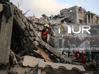 Palestinians are inspecting the damage to buildings after an Israeli bombardment in Deir Al-Balah, in the central Gaza Strip, on April 30, 2...