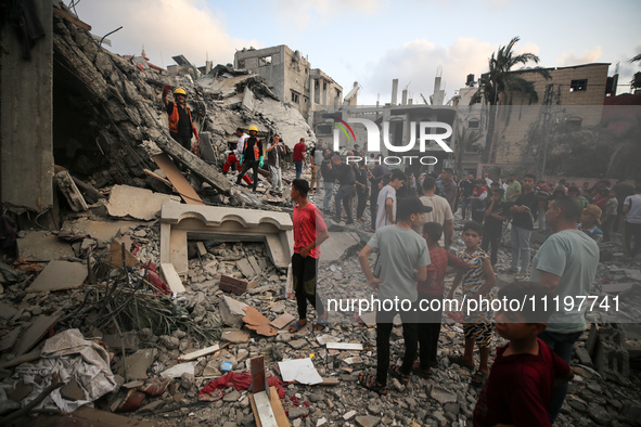 Palestinians are inspecting the damage to buildings after an Israeli bombardment in Deir Al-Balah, in the central Gaza Strip, on April 30, 2...