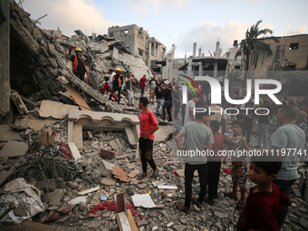 Palestinians are inspecting the damage to buildings after an Israeli bombardment in Deir Al-Balah, in the central Gaza Strip, on April 30, 2...