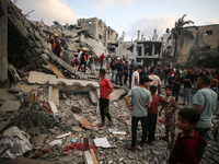 Palestinians are inspecting the damage to buildings after an Israeli bombardment in Deir Al-Balah, in the central Gaza Strip, on April 30, 2...