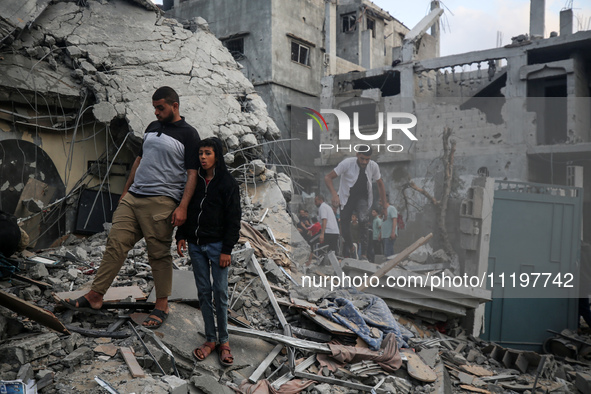 Palestinians are inspecting the damage to buildings after an Israeli bombardment in Deir Al-Balah, in the central Gaza Strip, on April 30, 2...