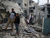 Palestinians are inspecting the damage to buildings after an Israeli bombardment in Deir Al-Balah, in the central Gaza Strip, on April 30, 2...