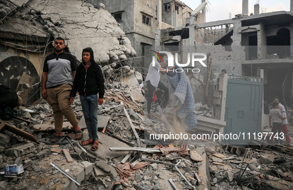 Palestinians are inspecting the damage to buildings after an Israeli bombardment in Deir Al-Balah, in the central Gaza Strip, on April 30, 2...