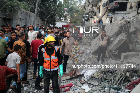 Palestinians are inspecting the damage to buildings after an Israeli bombardment in Deir Al-Balah, in the central Gaza Strip, on April 30, 2...