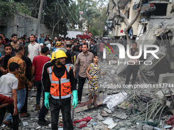 Palestinians are inspecting the damage to buildings after an Israeli bombardment in Deir Al-Balah, in the central Gaza Strip, on April 30, 2...