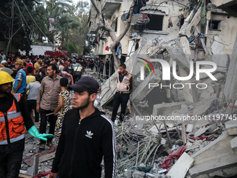 Palestinians are inspecting the damage to buildings after an Israeli bombardment in Deir Al-Balah, in the central Gaza Strip, on April 30, 2...