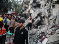 Palestinians are inspecting the damage to buildings after an Israeli bombardment in Deir Al-Balah, in the central Gaza Strip, on April 30, 2...