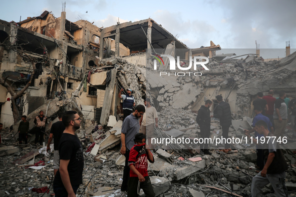 Palestinians are inspecting the damage to buildings after an Israeli bombardment in Deir Al-Balah, in the central Gaza Strip, on April 30, 2...