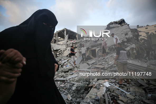 Palestinians are inspecting the damage to buildings after an Israeli bombardment in Deir Al-Balah, in the central Gaza Strip, on April 30, 2...