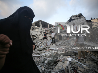 Palestinians are inspecting the damage to buildings after an Israeli bombardment in Deir Al-Balah, in the central Gaza Strip, on April 30, 2...