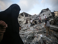 Palestinians are inspecting the damage to buildings after an Israeli bombardment in Deir Al-Balah, in the central Gaza Strip, on April 30, 2...