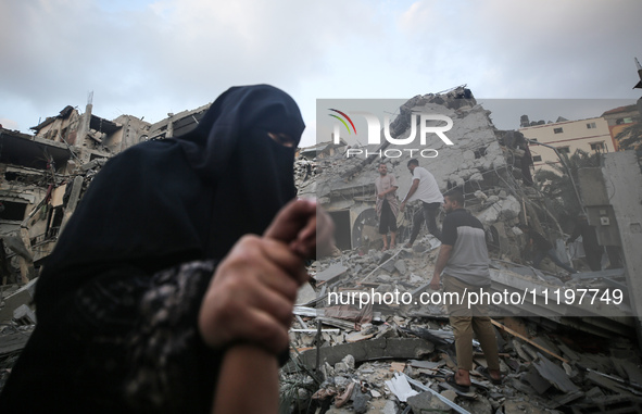 Palestinians are inspecting the damage to buildings after an Israeli bombardment in Deir Al-Balah, in the central Gaza Strip, on April 30, 2...