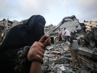 Palestinians are inspecting the damage to buildings after an Israeli bombardment in Deir Al-Balah, in the central Gaza Strip, on April 30, 2...