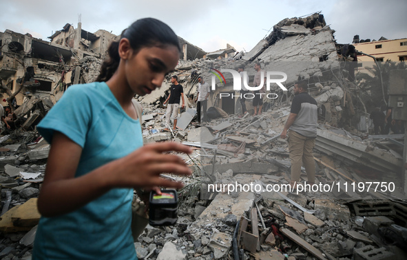 Palestinians are inspecting the damage to buildings after an Israeli bombardment in Deir Al-Balah, in the central Gaza Strip, on April 30, 2...