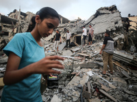 Palestinians are inspecting the damage to buildings after an Israeli bombardment in Deir Al-Balah, in the central Gaza Strip, on April 30, 2...