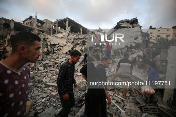 Palestinians are inspecting the damage to buildings after an Israeli bombardment in Deir Al-Balah, in the central Gaza Strip, on April 30, 2...