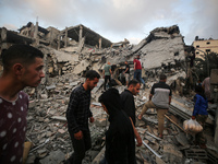 Palestinians are inspecting the damage to buildings after an Israeli bombardment in Deir Al-Balah, in the central Gaza Strip, on April 30, 2...