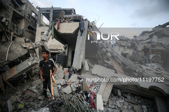 Palestinians are inspecting the damage to buildings after an Israeli bombardment in Deir Al-Balah, in the central Gaza Strip, on April 30, 2...