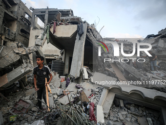 Palestinians are inspecting the damage to buildings after an Israeli bombardment in Deir Al-Balah, in the central Gaza Strip, on April 30, 2...