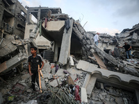 Palestinians are inspecting the damage to buildings after an Israeli bombardment in Deir Al-Balah, in the central Gaza Strip, on April 30, 2...