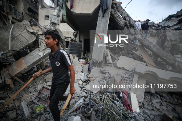 Palestinians are inspecting the damage to buildings after an Israeli bombardment in Deir Al-Balah, in the central Gaza Strip, on April 30, 2...