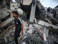 Palestinians are inspecting the damage to buildings after an Israeli bombardment in Deir Al-Balah, in the central Gaza Strip, on April 30, 2...