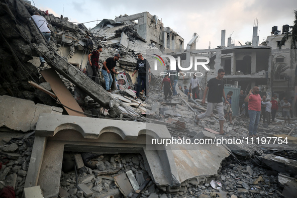 Palestinians are inspecting the damage to buildings after an Israeli bombardment in Deir Al-Balah, in the central Gaza Strip, on April 30, 2...