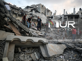 Palestinians are inspecting the damage to buildings after an Israeli bombardment in Deir Al-Balah, in the central Gaza Strip, on April 30, 2...