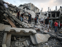 Palestinians are inspecting the damage to buildings after an Israeli bombardment in Deir Al-Balah, in the central Gaza Strip, on April 30, 2...