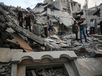 Palestinians are inspecting the damage to buildings after an Israeli bombardment in Deir Al-Balah, in the central Gaza Strip, on April 30, 2...