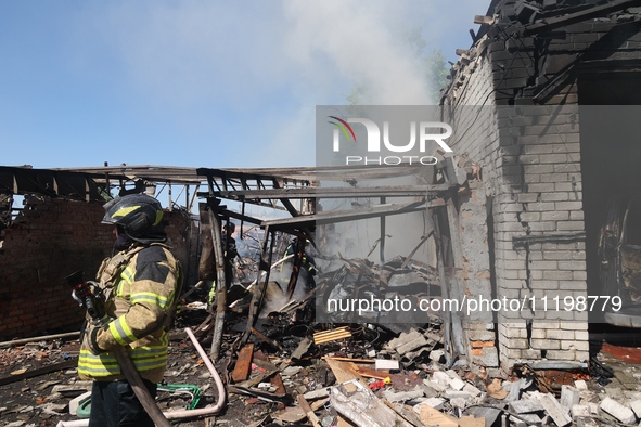 A rescuer is dealing with the aftermath of a Russian KAB aerial bomb attack in Kharkiv, northeastern Ukraine, on April 30, 2024. 