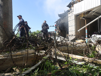 Rescuers are dealing with the aftermath of a Russian KAB aerial bomb attack in Kharkiv, northeastern Ukraine, on April 30, 2024. (