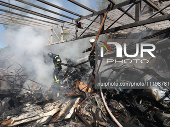 Rescuers are dealing with the aftermath of a Russian KAB aerial bomb attack in Kharkiv, northeastern Ukraine, on April 30, 2024. (