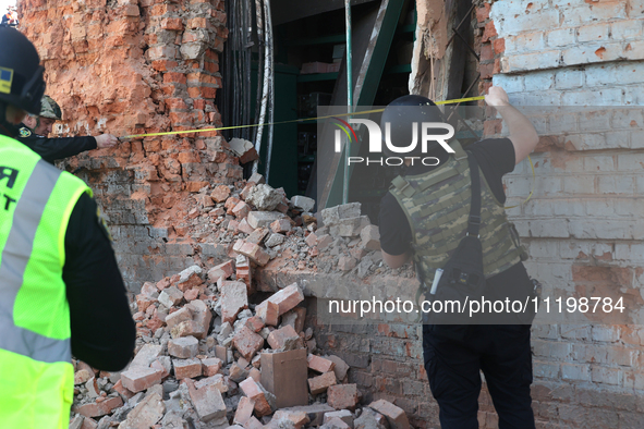 Law enforcers are documenting the destruction caused by the strike of Russian KAB guided bombs in Kharkiv, northeastern Ukraine, on April 30...