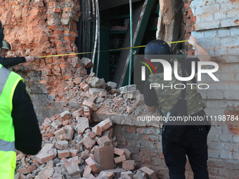 Law enforcers are documenting the destruction caused by the strike of Russian KAB guided bombs in Kharkiv, northeastern Ukraine, on April 30...