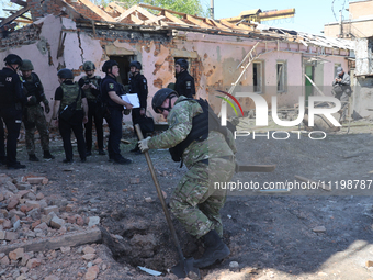 Law enforcers are documenting the destruction caused by the strike of Russian KAB guided bombs in Kharkiv, northeastern Ukraine, on April 30...