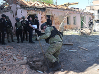 Law enforcers are documenting the destruction caused by the strike of Russian KAB guided bombs in Kharkiv, northeastern Ukraine, on April 30...