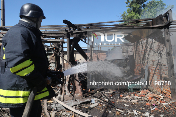 A rescuer is dealing with the aftermath of a Russian KAB aerial bomb attack in Kharkiv, northeastern Ukraine, on April 30, 2024. 