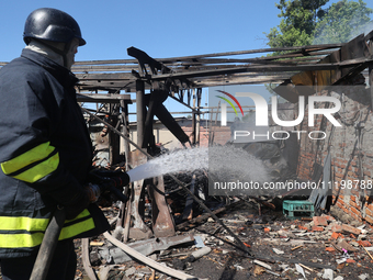 A rescuer is dealing with the aftermath of a Russian KAB aerial bomb attack in Kharkiv, northeastern Ukraine, on April 30, 2024. (